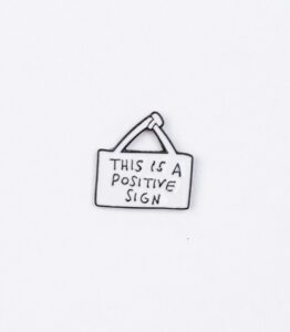 This is a Positive Sign Enamel Pin - #178